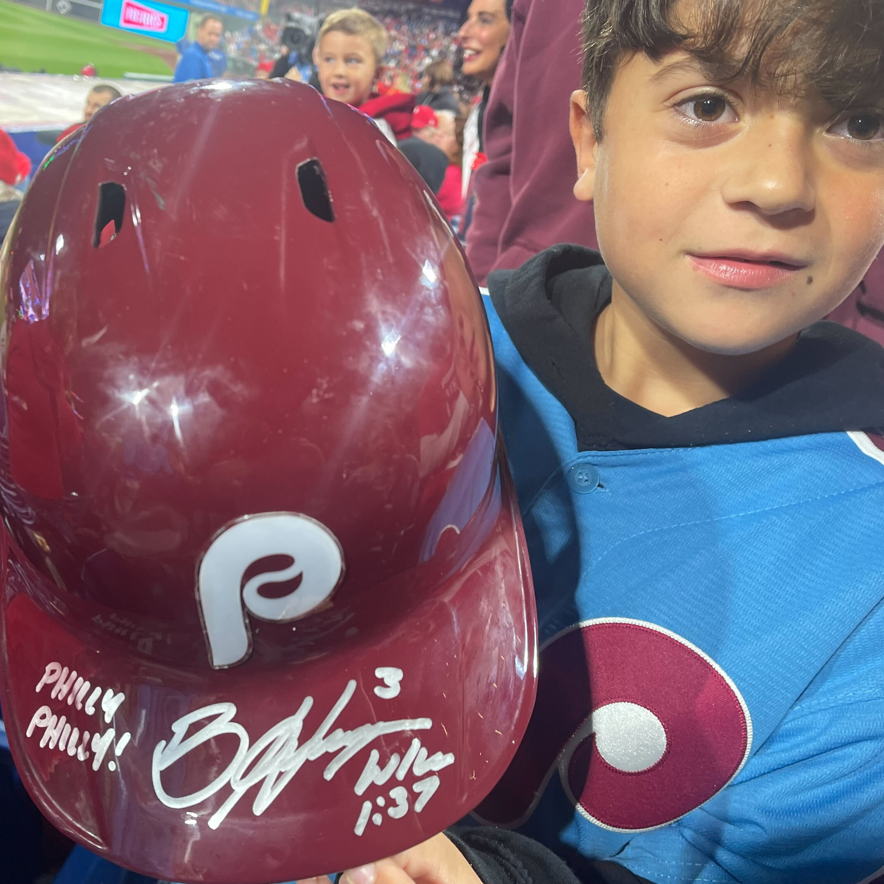 10-year-old Hayden Dorfman gets Bryce Harper's helmet after he threw it into the crowd