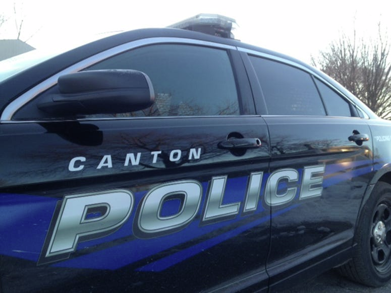 Elderly woman crashes into Canton garage, hits man in backyard