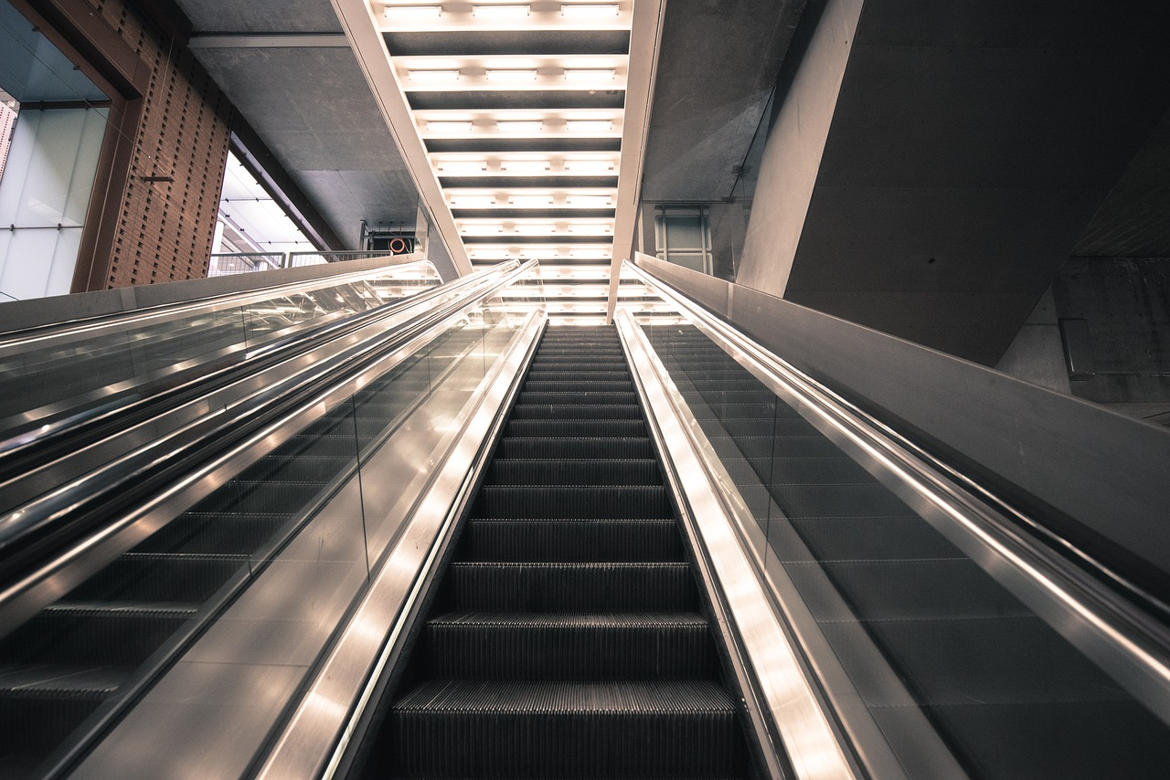 Woman falls from airport escalator