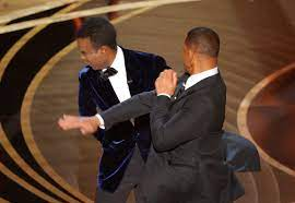 Will Smith hits Chris Rock on stage at the Oscars - tap for more